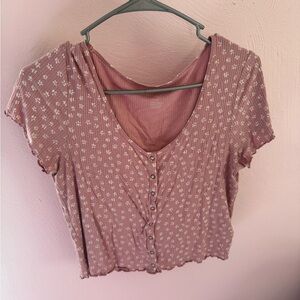 A cropped T-shirt from American Eagle and it is a size Large. It also buttons up